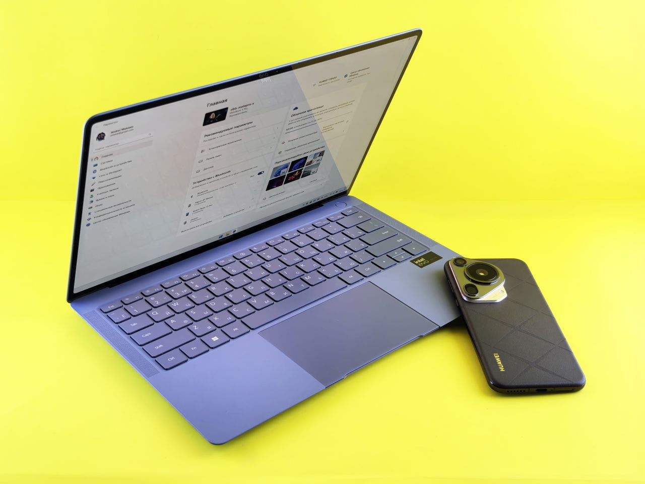A sleek laptop and smartphone set against a vibrant yellow background, showcasing modern technology.